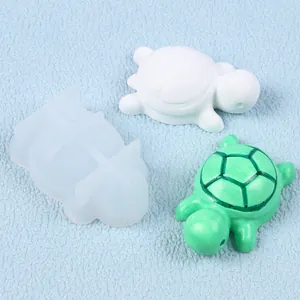Detail view of mini turtle silicone mold with white and green finished turtle crafts