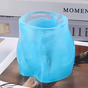 Detailed macro view of a light blue marble-textured buttock-shaped resin flower pot
