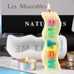 Detailed view of the wavy silicone mold and a finished 'MELT ME' letter scented candle