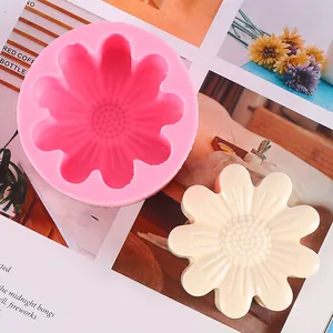 Close-up of pink silicone chrysanthemum mold with a white flower-shaped soap sample