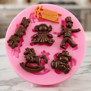 Detail of pink cartoon silicone mold with chocolate toy shapes on a marble surface
