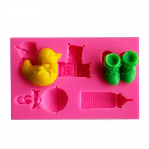 Detailed view of pink baby themed silicone fondant mold with duck and shoe shapes.
