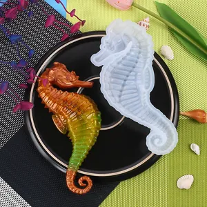 Detailed view of DIY seahorse silicone mold and finished resin figurine on a plate