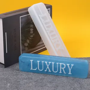 Close-up of DIY silicone mold with LUXURY text for making resin pet tags and ornaments.