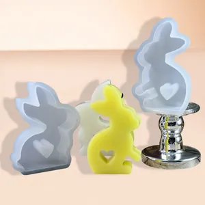 Close-up of cute Easter bunny silicone molds and finished wax candle featuring a heart