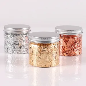 Close-up of gold, silver, and rose gold foil flakes in jars for DIY resin art and painting