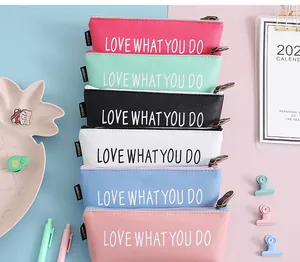 Detailed view of six stacked colorful PU leather pencil cases with cute slogans