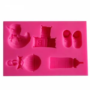 Pink liquid silicone mold featuring baby-themed shapes for fondant cake decorating