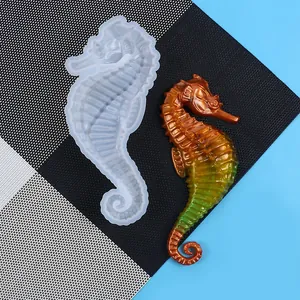 Detailed view showing a translucent seahorse silicone mold and a gradient resin finished craft
