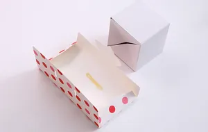 Detail view of DIY explosion jumping gift box with red polka dots and elastic band
