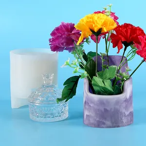 Detailed view showing the silicone mold next to a finished marbled resin flower pot