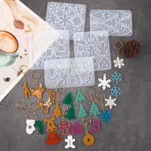 View of multiple Christmas silicone molds and finished colorful resin keychains