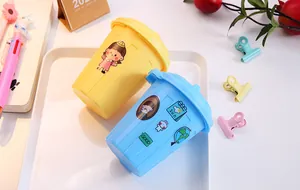 Miniature desktop storage bins in blue and yellow with cute cartoon stickers for desk organization