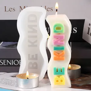 Detailed macro shot of wavy silicone candle mold and colorful Be Kind wax candle