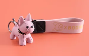 Détail en gros plan d'un porte-clés bouledogue français rose avec dragonne en cuir