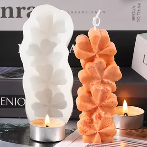 Close-up of heart-shaped silicone candle mold with finished orange clover candle