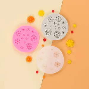 Detailed view of three circular daisy flower silicone molds with colorful flower samples