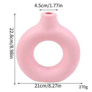 Detail view showing dimensions of pink donut-shaped plastic vase ornament