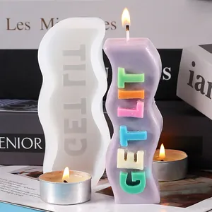 Close-up detail of wavy silicone candle mold alongside a finished 'GET LIT' slogan candle.