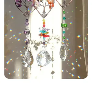 Detail view of heart-shaped tree of life crystal suncatchers with rainbow light spots