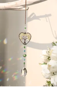 Detailed view of Tree of Life crystal suncatcher with heart wire wrap and beads