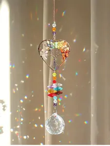 Macro view of crystal suncatcher with Tree of Life heart design creating rainbow light