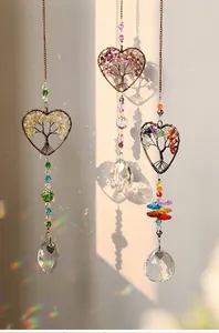 Close-up of heart tree of life suncatchers with vibrant rainbow light reflections.