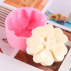 Macro detail showing a pink silicone flower mold and its cream white floral casting.