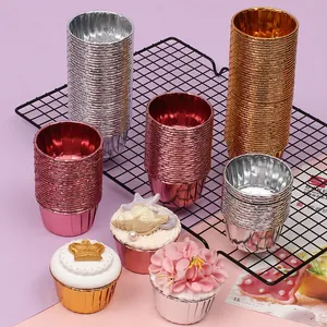 Assorted metallic cupcake liners in gold, silver, and rose gold with rolled edges.