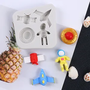 Silicone mold featuring astronaut, rocket, and satellite shapes for cake decorating