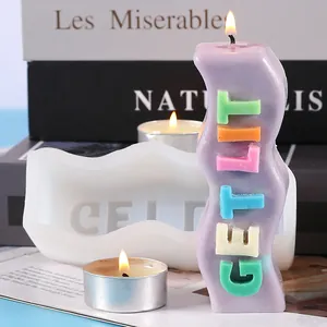 Close-up of DIY GET LIT wavy candle and its silicone mold with warm candle light setup