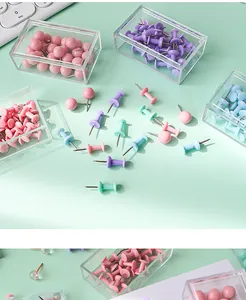 Close-up view of colorful assorted plastic push pins in transparent storage containers