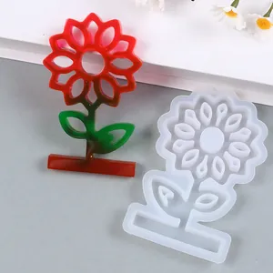 Detailed view of sunflower resin mold and finished red and green gradient flower ornament
