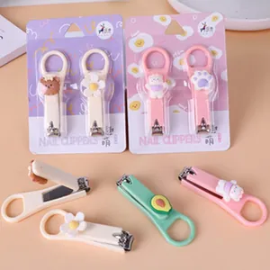 Detailed view of cartoon nail clippers set with cat paw, flower and avocado charms in packaging
