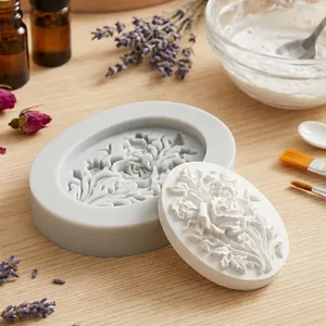 Detailed oval rose floral silicone mold with a white plaster craft casting on a wooden table