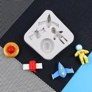 DIY space themed silicone mold for cake decoration featuring astronaut and rocket shapes