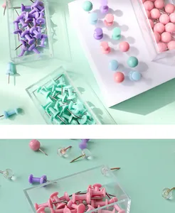 Detail macro view of pastel colorful push pins in clear storage boxes for office use.