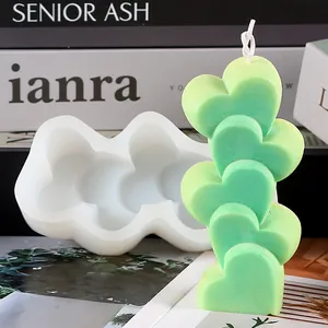 Detail of a 5-heart stacked candle and its white silicone mold for DIY craft projects