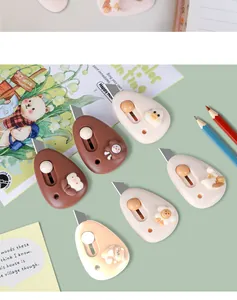 Close-up view of cute cartoon mini utility knives in various pastel colors and designs
