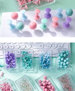 Detailed view of colorful push pins set in clear storage boxes for office use