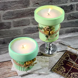 Detailed close-up of finished aromatic candles in green textured flower pot containers