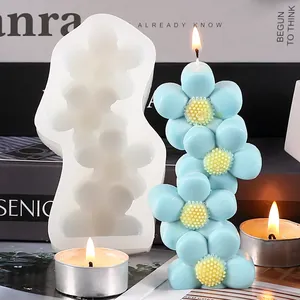Detailed view of DIY sunflower silicone mold and blue stacked flower scented candle