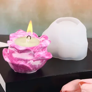 Detailed view of a flower silicone mold with a finished pink marbled aromatherapy candle