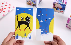 Detail of a DIY jumping box featuring a creative black cat and moon illustration.