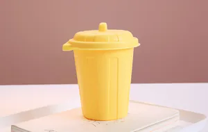 Macro view of a vibrant yellow mini desktop storage bin with lid for office organization