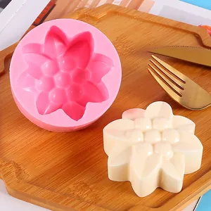Detailed view of a pink sunflower silicone mold with a finished white plaster cast