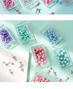 Detail macro view of colorful pastel macaron push pins stored in clear organizer boxes