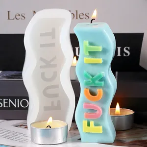 Detailed macro shot of wavy silicone mold and finished candle with FUCK IT slogan