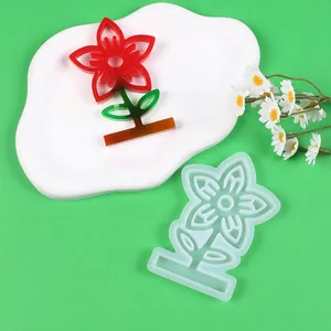 Translucent silicone flower mold and finished resin piece with decorative daisy props