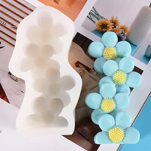 Close-up view of 5-linked flower silicone mold with finished blue resin daisies